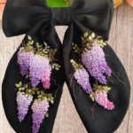 Elegant black hair bow with hand-embroidered purple blooms