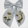 A white rose hair bow