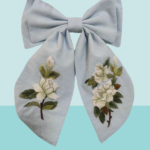 A white rose hair bow